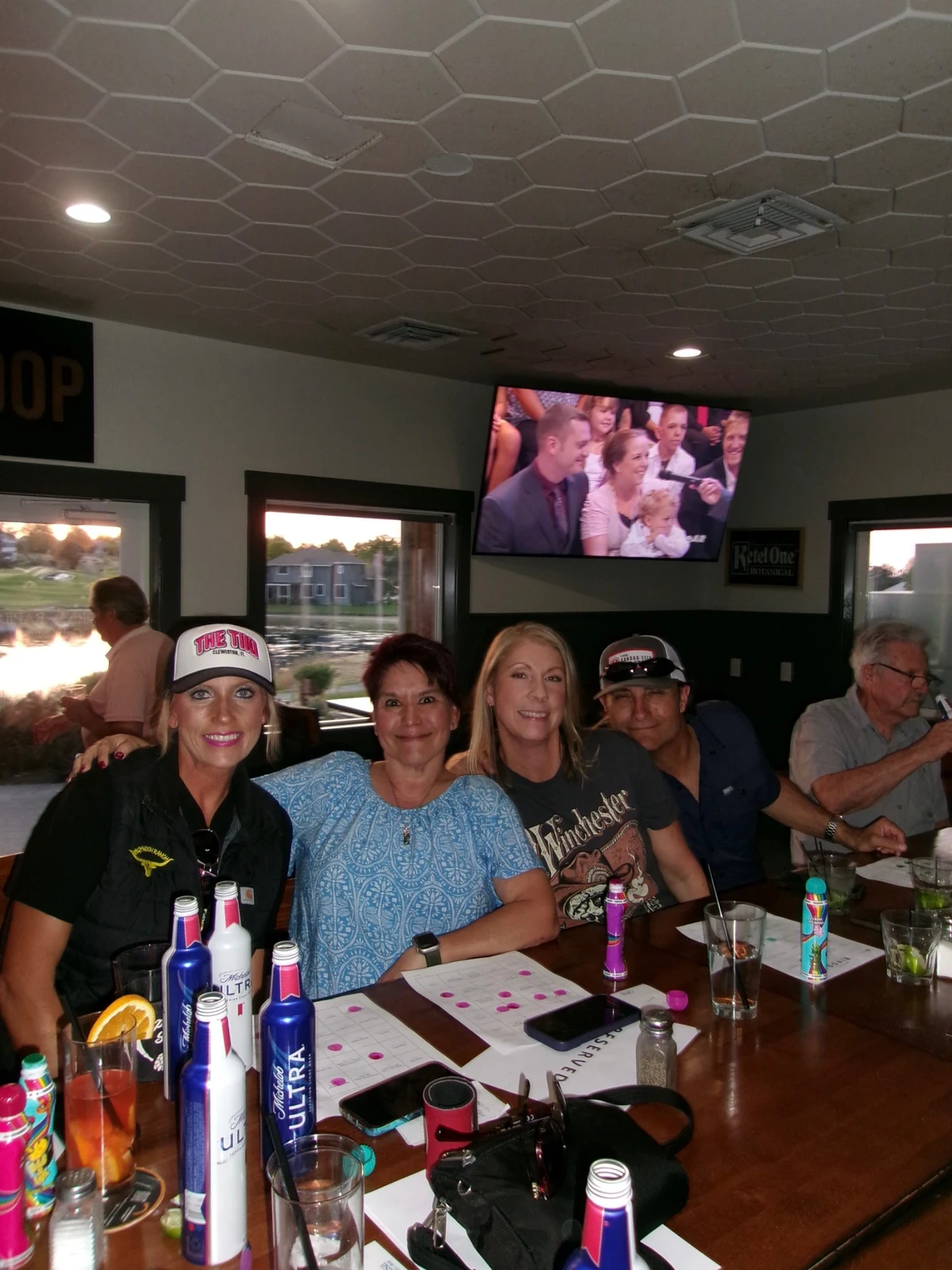 Friends gathered together around the Rewsters bar